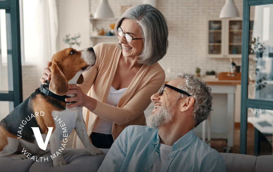 Older man and woman petting their dog.