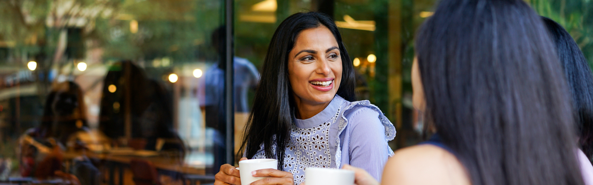 A woman is smiling at people in front of her.