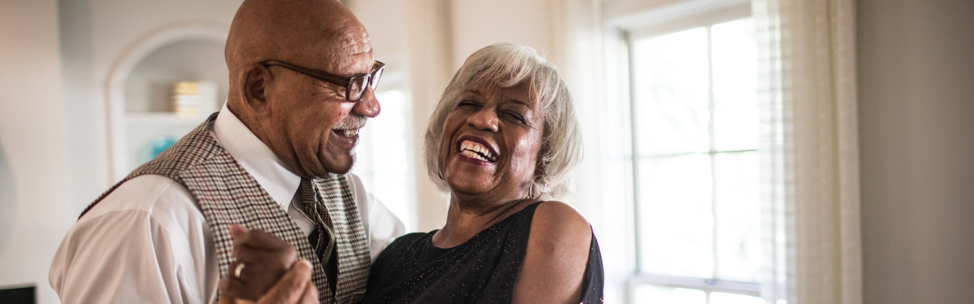 An older man is embracing an older woman.