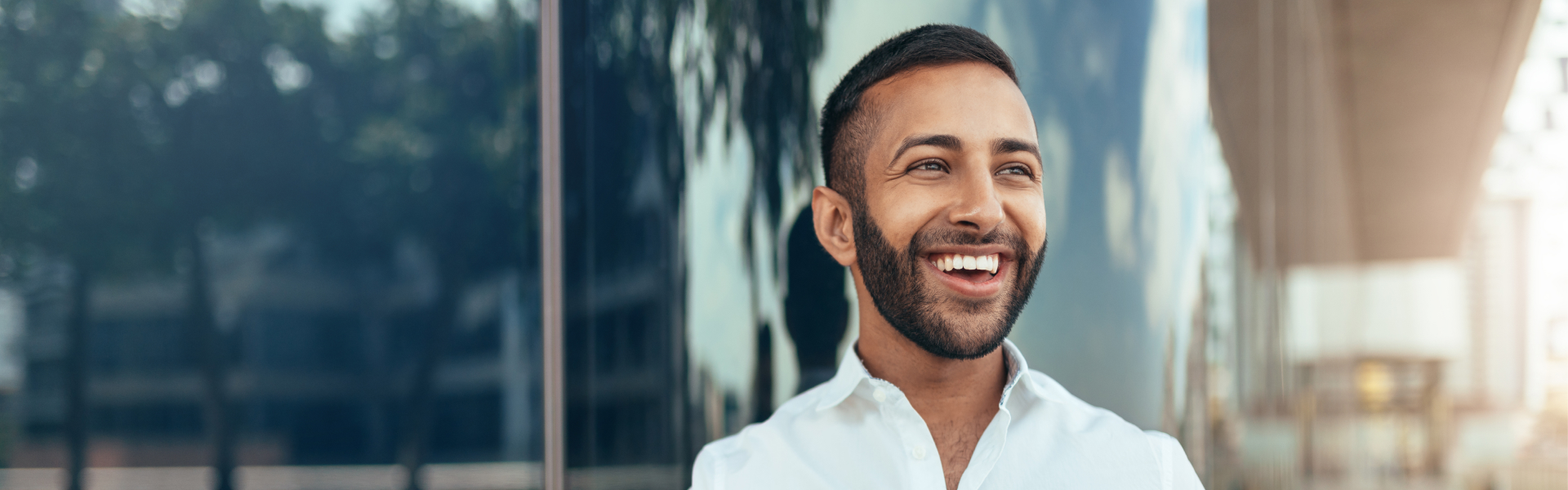 A young man is smiling.