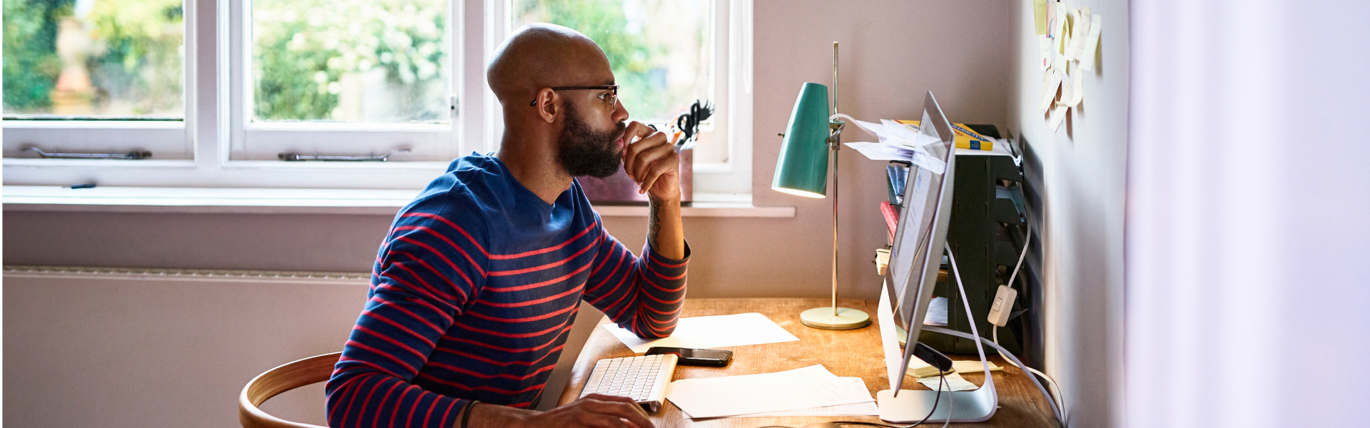 A man is working on a desktop computer.