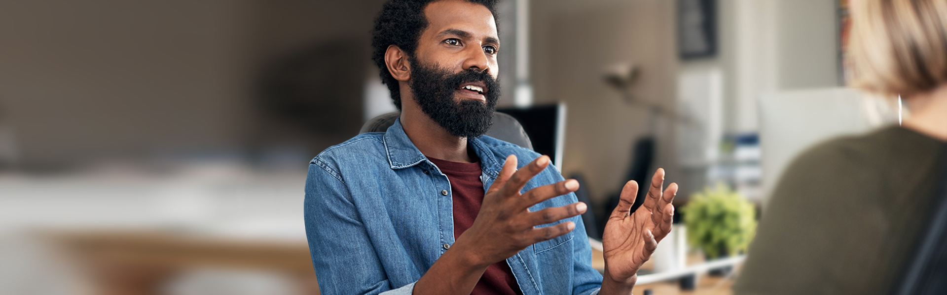 Man talks to woman in shop.