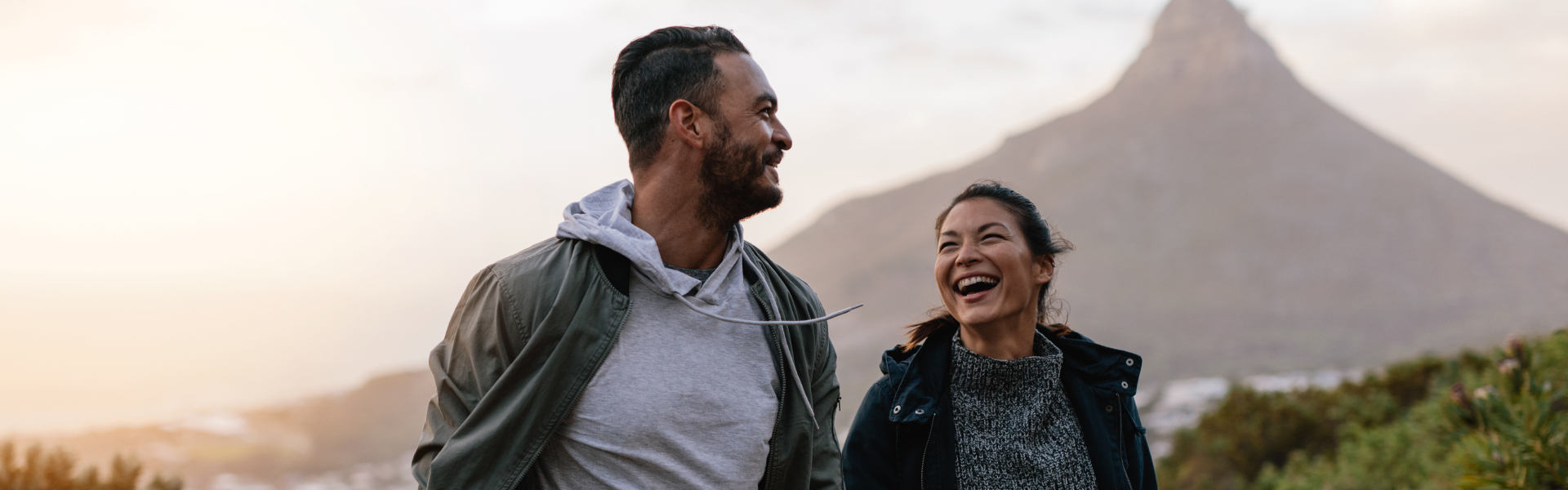 A man and woman are smiling at each other.
