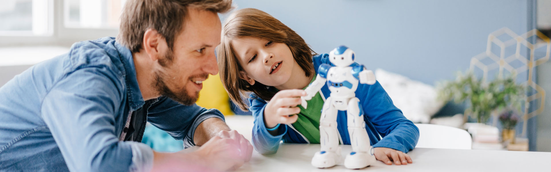 A young child is playing with a robot toy.	
