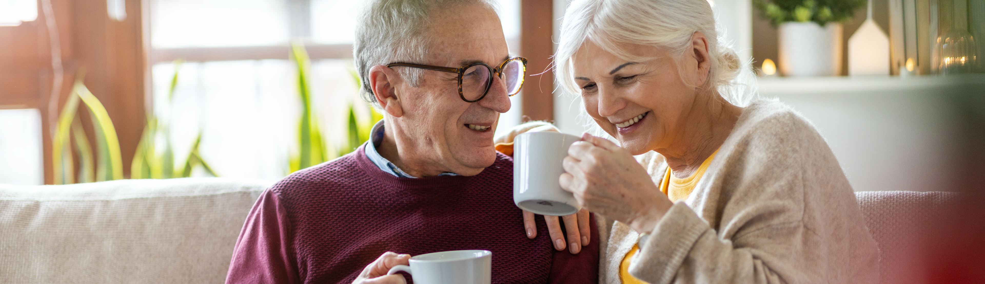 An older couple drinking coffee.